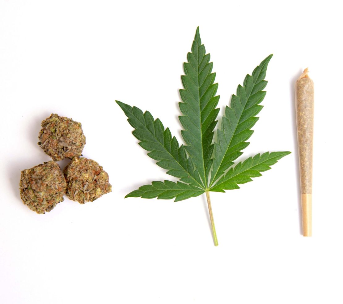 Three cannabis buds on the left, a cannabis leaf in the center, and a rolled joint on the right, all displayed against a plain background.