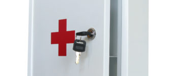 A first aid kit with a key in the lock.