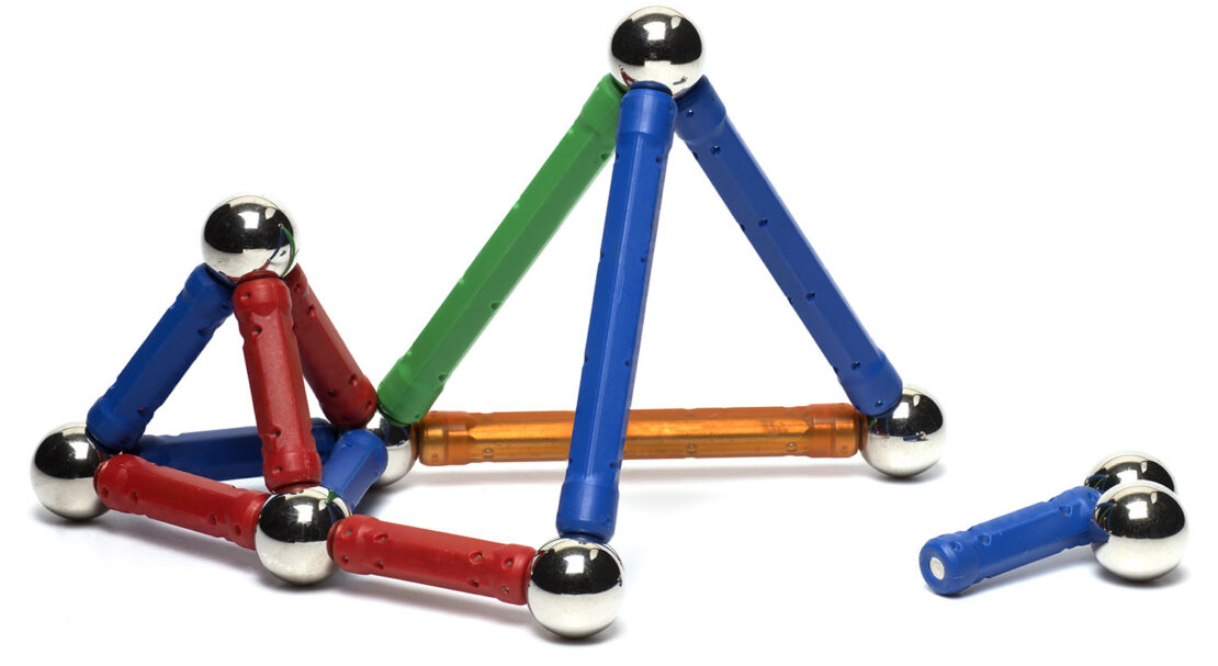 Colorful building rods assembled into a small structure, with circular magnets at each corner.