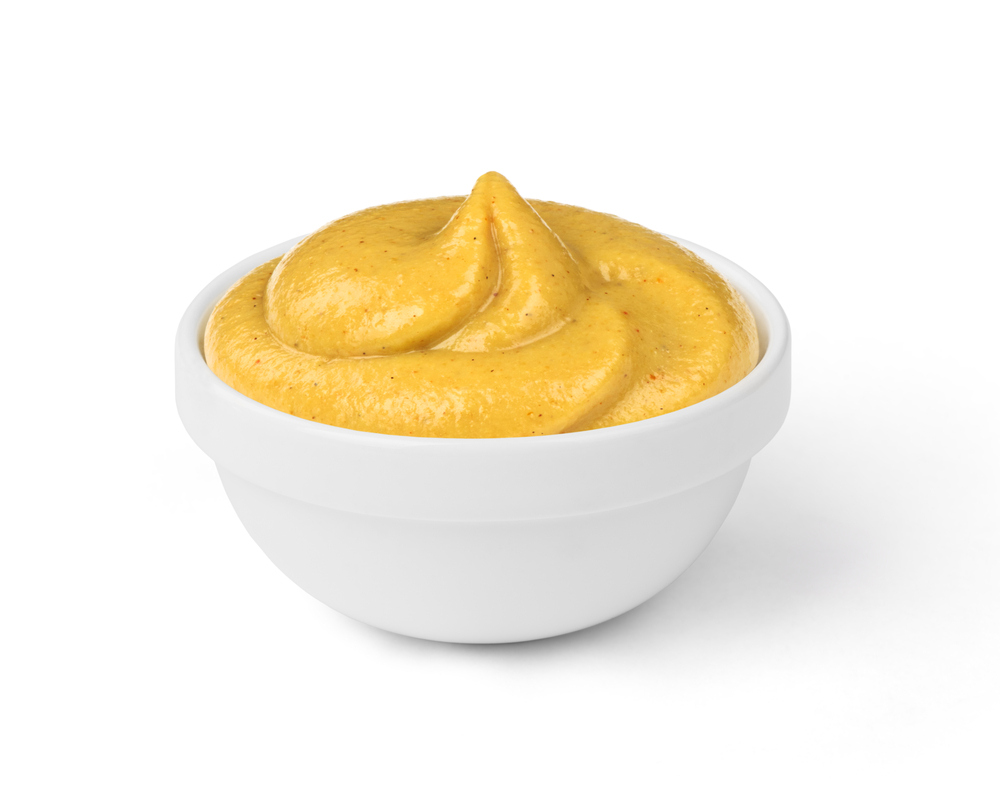 a bowl filled with yellow mustard
