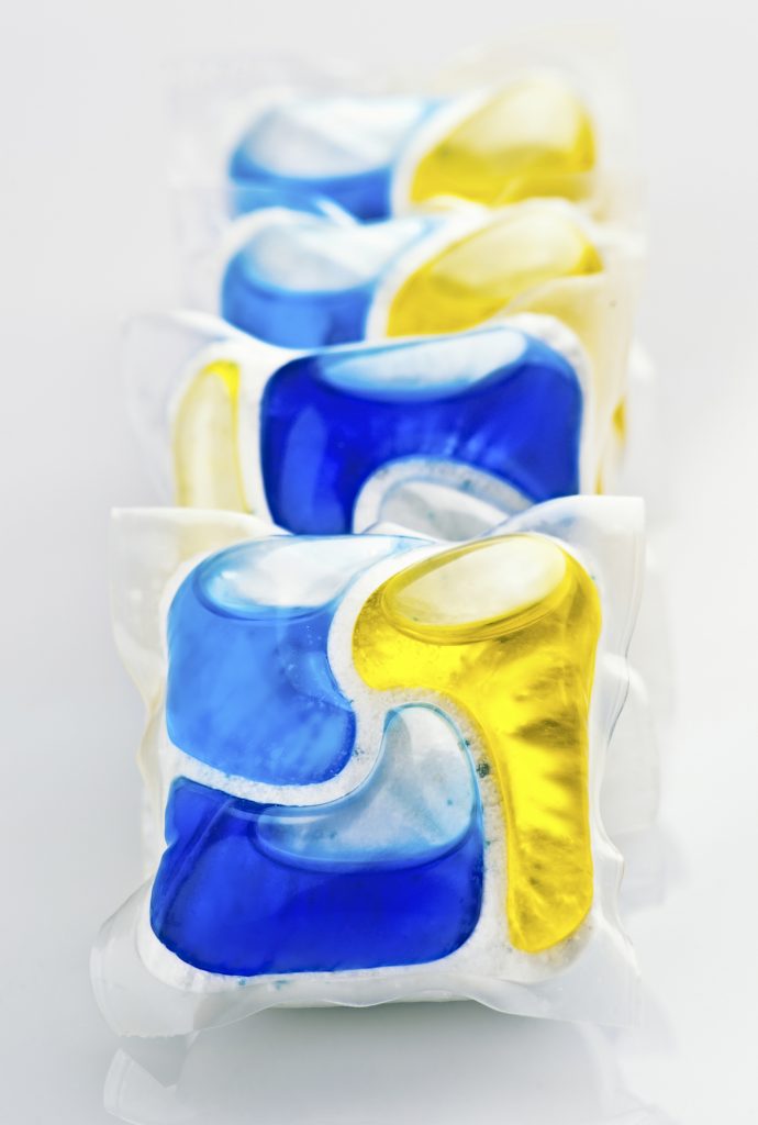 Four yellow, blue and white laundry pods